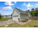 Exterior showcasing the house with light green siding, two car garage, and a well maintained backyard at 708 Overhills Rd, Linden, NC 28356