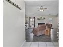 Inviting living room features a ceiling fan, dark wood floors, a fireplace, and a doorway leading outside at 708 Overhills Rd, Linden, NC 28356