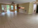 Bright living room with tile flooring, multiple windows, and an open layout with access to other rooms at 921 Pickard Rd, Sanford, NC 27330