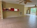Open living area with tile floors, bar seating to the kitchen, and plenty of natural light from windows at 921 Pickard Rd, Sanford, NC 27330