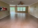 Spacious living room with tile flooring, ceiling fans, and sliding glass doors leading to an outdoor deck at 921 Pickard Rd, Sanford, NC 27330