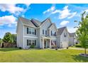 Beautiful two-story home with light blue siding, an attached garage, and a well-manicured lawn at 101 Shepard Dr, Linden, NC 28356