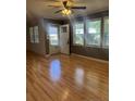 Bright living room with gleaming hardwood floors and large windows, offering plenty of natural light at 1017 Bailes Dr, Sanford, NC 27330
