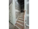 New wood stairway with a white handrail, perfect for getting to other floors in the home at 188 Landon Rdg, Sanford, NC 27330