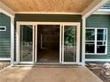 Covered patio with views into the unfinished construction through sliding glass doors and windows at 194 Landon Rdg, Sanford, NC 27330