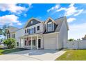 Charming two-story home featuring a covered front porch and an attached one-car garage at 21 Bicentennial Way, Cameron, NC 28326