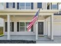 Inviting front porch with classic white columns and view of the front door at 21 Bicentennial Way, Cameron, NC 28326