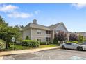 Exterior view of a two-story residential building with attractive landscaping and parking at 310 Gallery Dr # 201, Spring Lake, NC 28390