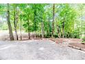 A beautiful stone walkway and gravel area is surrounded by towering trees at 3224 Green Valley Dr, Sanford, NC 27330