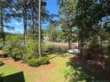 Lush backyard with mature trees, leading to a tranquil lake, ideal for relaxation and recreation at 39 Tahoe Cir, Sanford, NC 27332