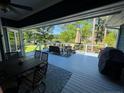 Spacious covered deck with outdoor dining and seating area, perfect for enjoying lake views at 39 Tahoe Cir, Sanford, NC 27332
