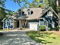 Beautiful blue two-story home featuring a stone entryway and attached two-car garage at 39 Tahoe Cir, Sanford, NC 27332