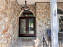 Inviting front porch with stone accents, decorative lighting and outdoor seating area at 39 Tahoe Cir, Sanford, NC 27332