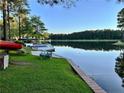 Picturesque waterfront with a wooden dock, boats, and serene lake views at 39 Tahoe Cir, Sanford, NC 27332