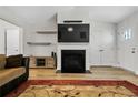 Bright living room featuring a fireplace, hardwood floors, modern decor, and plenty of natural light at 446 Placid Pond Dr, Broadway, NC 27505