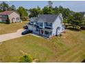 Spacious two-story home with a large backyard, two-car garage, and an inviting front porch at 495 Lenoir Dr, Spring Lake, NC 28390