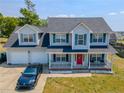 Beautiful home featuring a covered porch, a two-car garage, and a driveway in front at 495 Lenoir Dr, Spring Lake, NC 28390