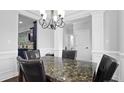 Bright dining room with dark accents, marble table, modern lighting, and column accents at 56 N Skipping Pines Ct, Spring Lake, NC 28390