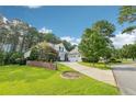 Landscaped front lawn of home with brick retaining wall and mature trees at 631 Anderson Creek Dr, Spring Lake, NC 28390