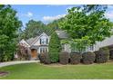 Well-manicured lawn and landscaping highlight this home's charming exterior at 631 Anderson Creek Dr, Spring Lake, NC 28390