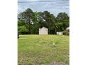 Exterior shot showcasing the expansive yard and detached garage of the home's property at 1203 S 3Rd St, Lillington, NC 27546