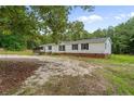 Charming single story home featuring a white facade, black shutters, and well-maintained landscaping at 171 Waters Way, Lillington, NC 27546