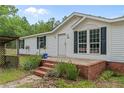 Inviting front entrance with brick steps, updated door, and charming landscaping at 171 Waters Way, Lillington, NC 27546