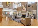 Spacious living room with soaring ceilings, fireplace, hardwood floors, and an abundance of natural light at 20017 Bragg, Chapel Hill, NC 27517