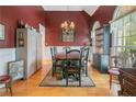 Elegant dining room with hardwood floors, wainscoting, and a stylish chandelier at 42 Skipping Water Dr, Spring Lake, NC 28390