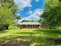Charming brick home with a well-maintained front yard, a covered porch, and inviting curb appeal at 5163 Odell King Rd, Burlington, NC 27217
