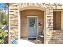 Charming covered front porch with stone archway, light blue door and home number at 76 Slate Dr, Spring Lake, NC 28390