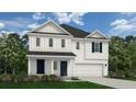 Charming two-story home with white siding, dark shutters, a two-car garage, and a well-manicured front lawn at 78 Blossom Trl, Lillington, NC 27546