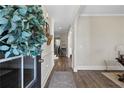 Elegant foyer with wood floors, a decorative wreath, and arched doorways leading to other rooms at 102 Scholar Dr, Spring Lake, NC 28390