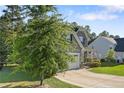 View of attractive gray home with manicured lawn and stone accents at 102 Scholar Dr, Spring Lake, NC 28390