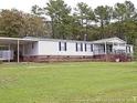 Single story home featuring covered parking and a front porch at 104 Beacon Ln, Cameron, NC 28326
