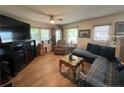 Cozy living room featuring wood floors, a large television, and comfortable seating at 12558 Mcdougald Rd, Broadway, NC 27505