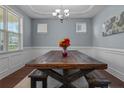 Formal dining room with modern chandelier and a rustic wood table with bench seating at 170 Valley Stream Rd, Spring Lake, NC 28390