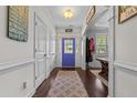 Bright foyer with wood floors, a colorful front door, and decorative wall art at 170 Valley Stream Rd, Spring Lake, NC 28390
