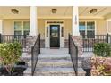 Inviting covered front porch with stone steps and decorative iron railing at 170 Valley Stream Rd, Spring Lake, NC 28390