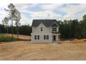 Two-story home featuring gray siding, black shutters, and a newly installed roof amidst a partially cleared lot at 206 Uwharrie Way, Sanford, NC 27330