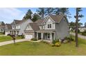 Attractive two-story home with stone accents, manicured lawn, attached two-car garage and welcoming curb appeal at 22 Education Dr, Spring Lake, NC 28390