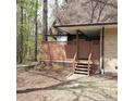 Charming brick home with a fenced entry, wooden steps and mature trees at 240 Brookberry Cir, Chapel Hill, NC 27517