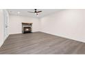 Spacious living room featuring a cozy fireplace and new flooring, perfect for relaxing or entertaining at 240 Brookberry Cir, Chapel Hill, NC 27517