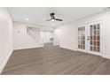 Bright living room with modern flooring, ceiling fan, and a staircase leading to the upper level at 240 Brookberry Cir, Chapel Hill, NC 27517