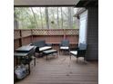 Relaxing outdoor patio with comfortable seating, grill, and a view of the surrounding trees at 240 Brookberry Cir, Chapel Hill, NC 27517