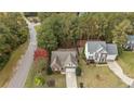 Aerial view of home nestled among mature trees, showcasing the neighborhood's quiet location at 35 Shining Water Ln, Spring Lake, NC 28390