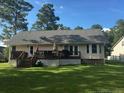 Large backyard with a spacious wooden deck, perfect for outdoor entertaining and relaxation at 49 Pebble Beach Pt, Sanford, NC 27332