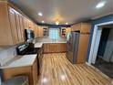 Well-lit kitchen featuring wood cabinets, stainless steel appliances, and a bright window over the sink at 73 Night Heron Ct, Sanford, NC 27332
