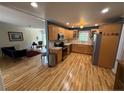 Open kitchen with wood cabinets, stainless steel appliances, and hardwood floors, offering a functional layout at 73 Night Heron Ct, Sanford, NC 27332