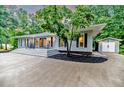 Exterior showcasing a well-maintained house, detached garage, and lovely yard at 220 Topside, Sanford, NC 27332